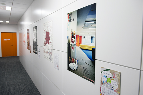 デジタルハリウッド大学、デジタルハリウッド大学院の学生たちが学ぶ3階。白い壁にオレンジのトビラ、メリハリの効いた色彩が心地よい