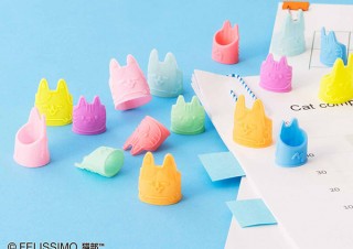 フェリシモ、猫の手を借りた気分で事務作業ができるカラフルな猫型指サックを発売